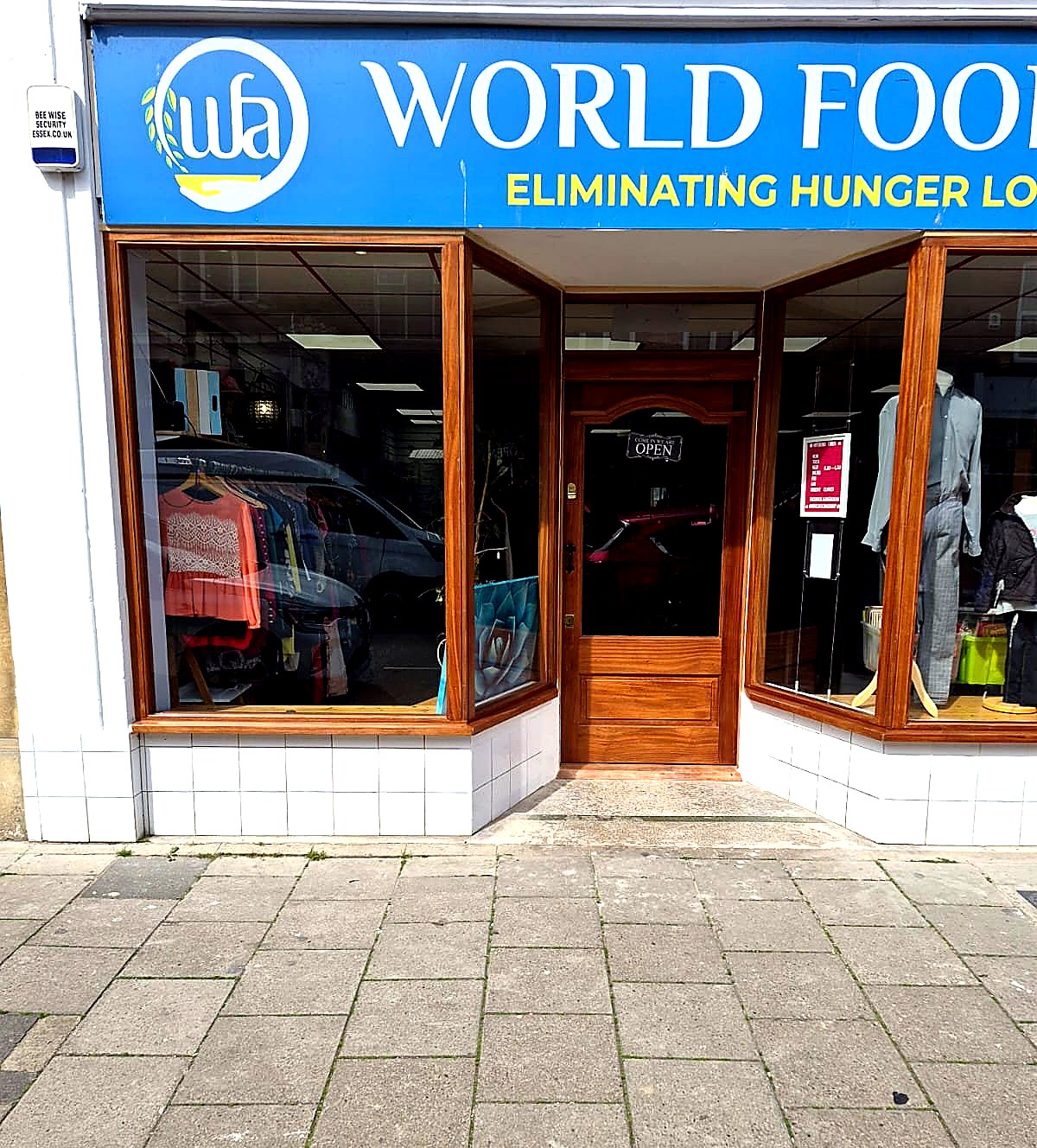 Detail of the timber frontage showing the bay-window configuration, traditional door and fascia signage band