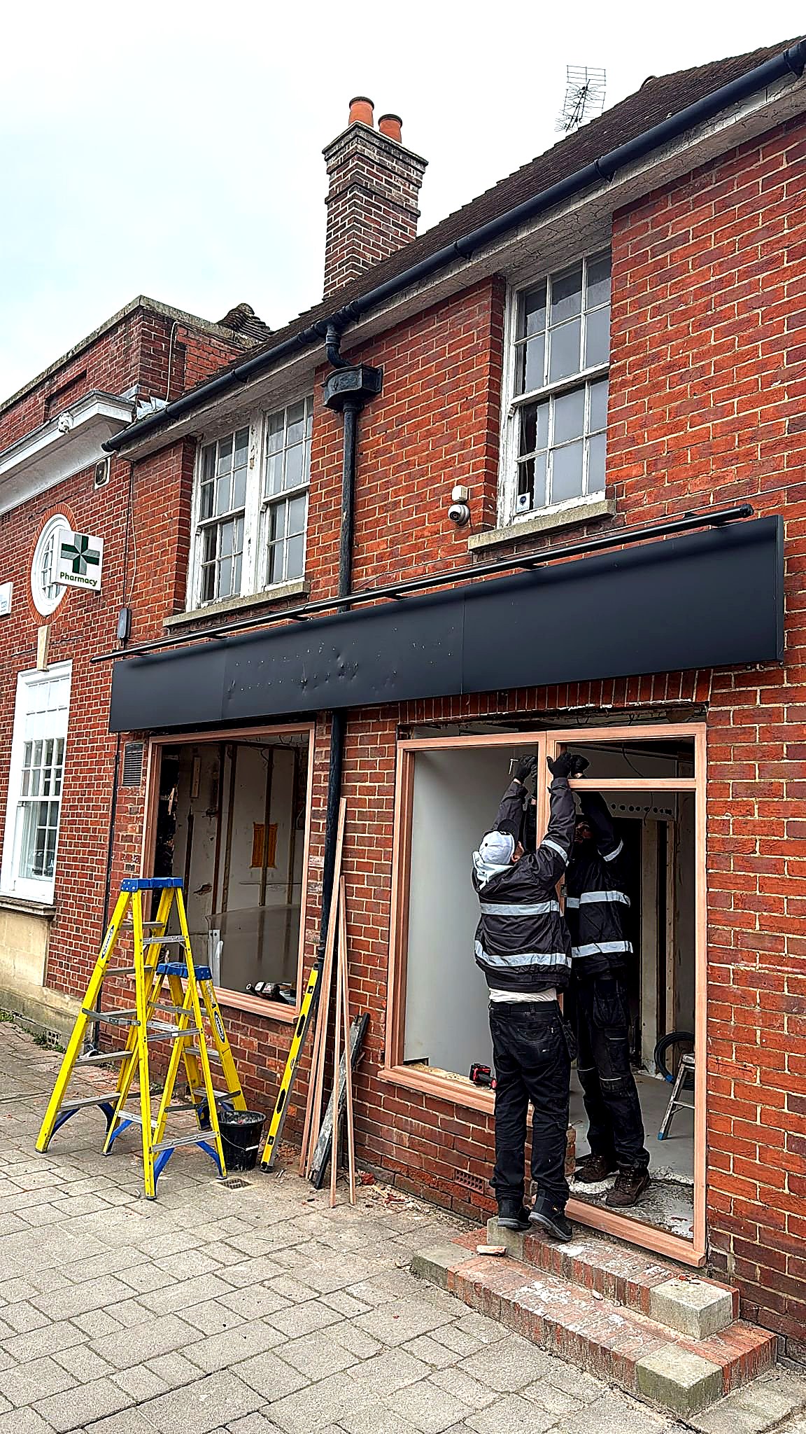 Mid-install: fitters working on the new window frames