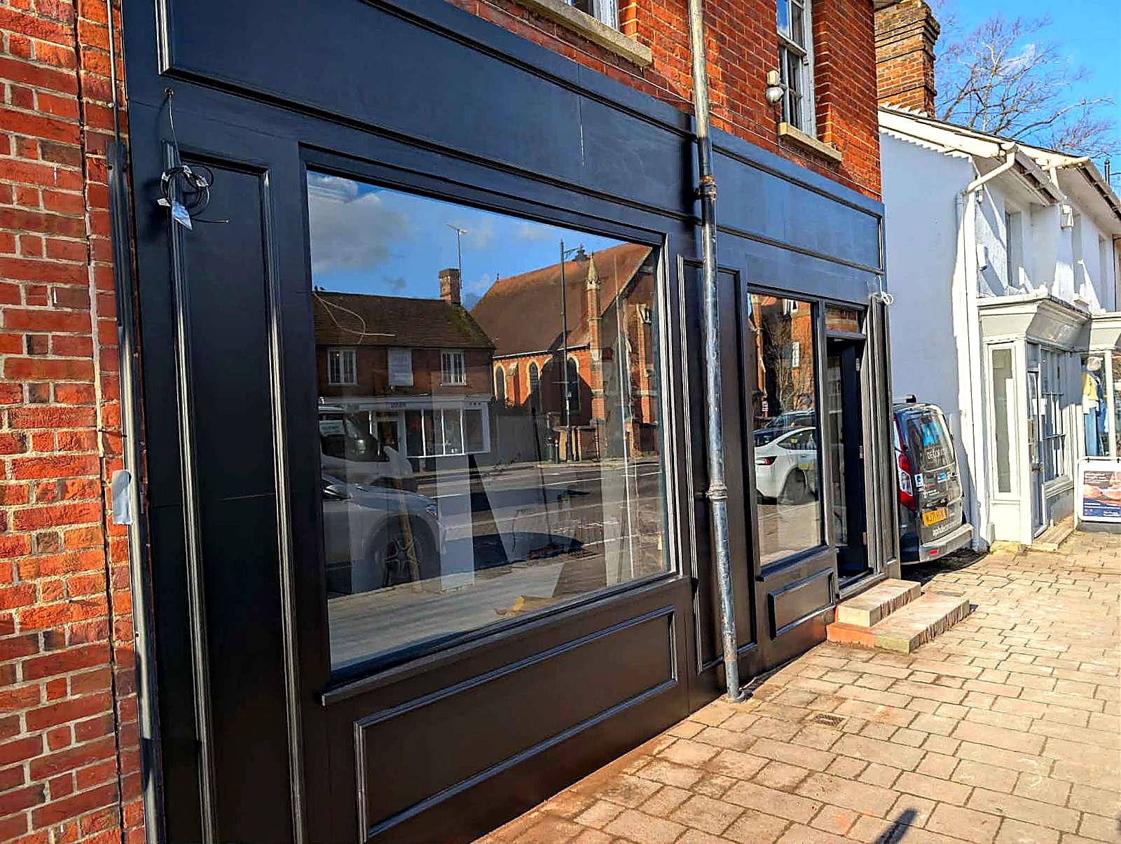 After — side angle showing the new windows and door, near complete