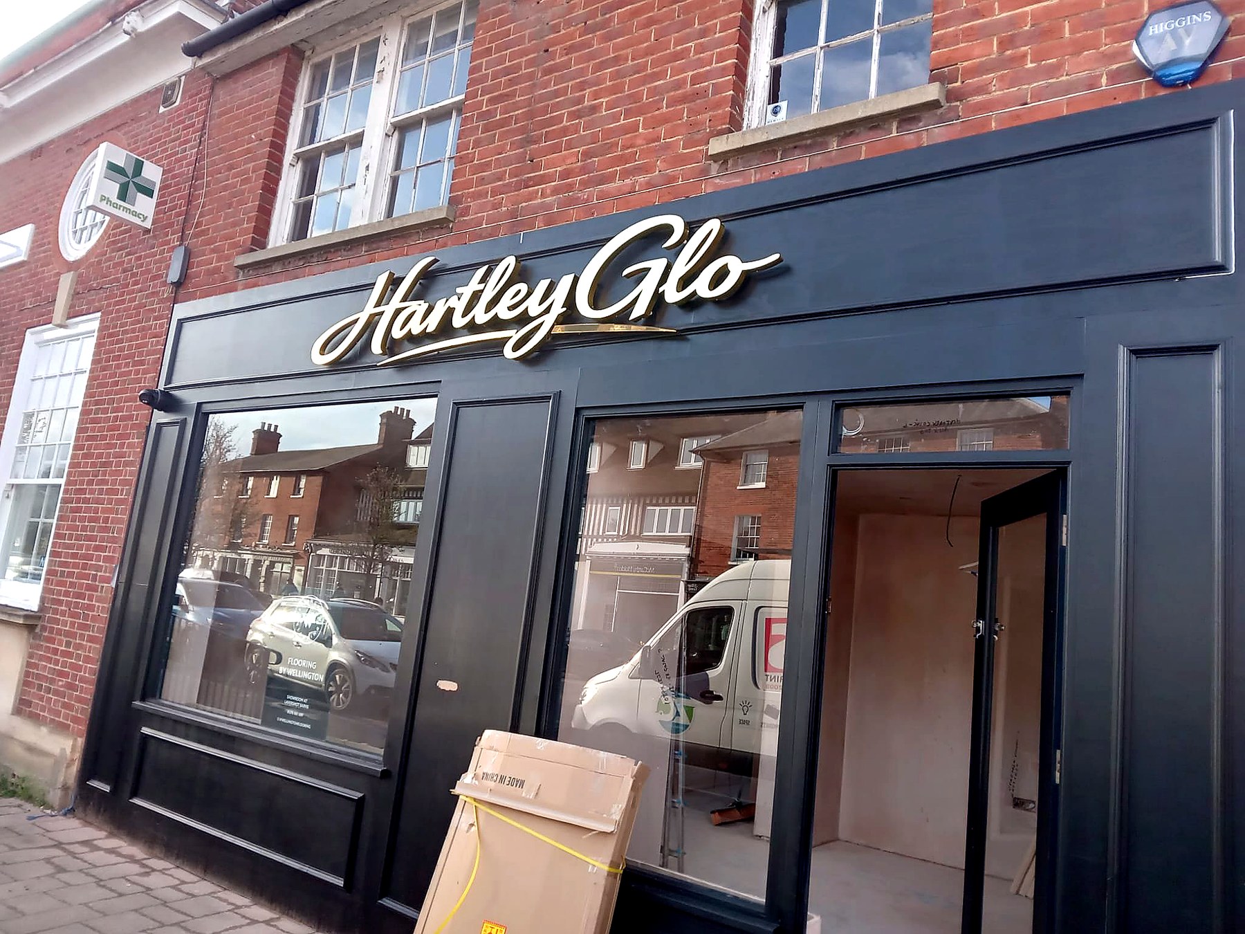 After — gold dimensional script signage just fitted, packaging still on site