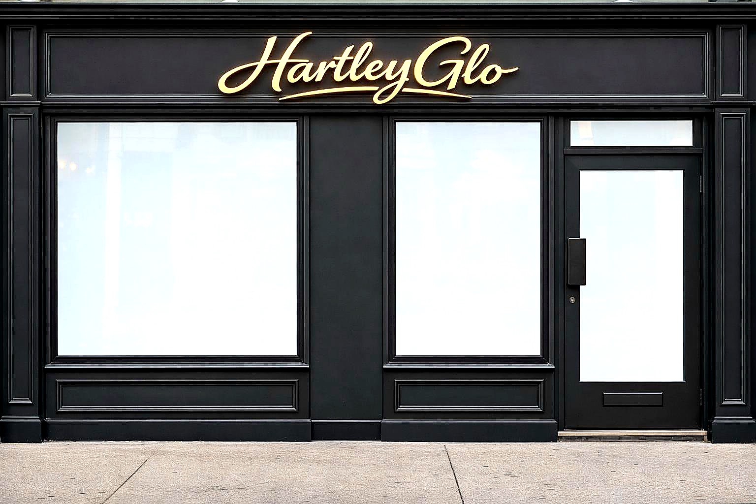 Hartley Glo premium black timber shopfront with gold script signage in Hartley Wintney, Hampshire